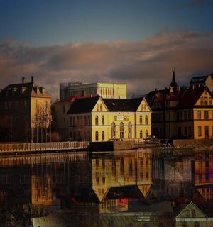 A panoramic view of a large body of water in Reykjavik, reflecting the city's skyline and surrounding landscapes
